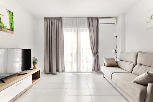 Apartment Torrevieja close to the sea bright living room with sofa TV and terrace access