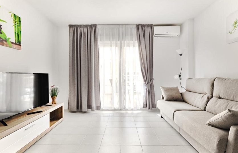 Apartment Torrevieja close to the sea bright living room with sofa TV and terrace access