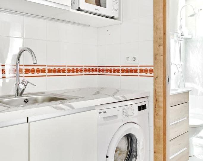 Apartment Torrevieja close to the sea kitchen detail with washing machine and storage cabinets