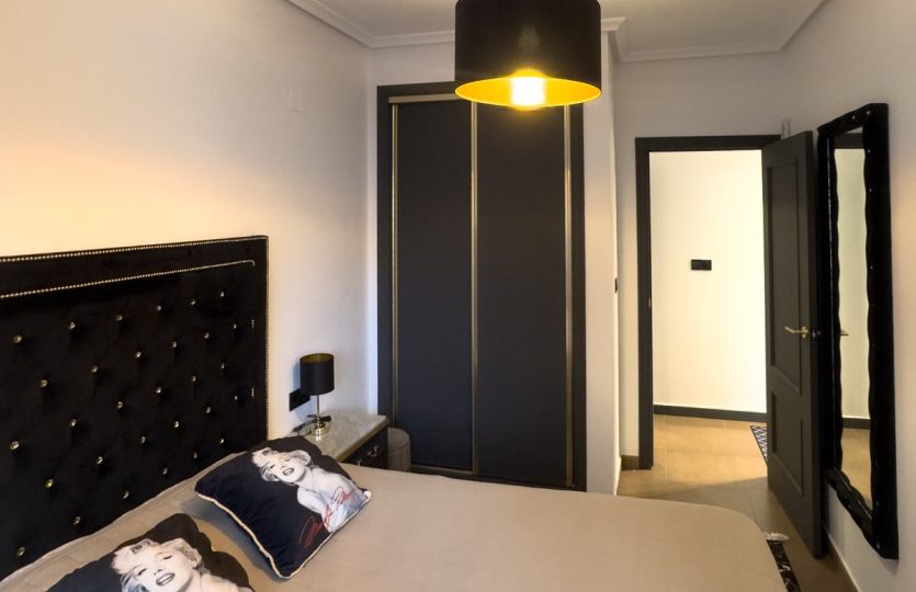 Rent in Torrevieja – Modern 2 Bedroom Apartment Bedroom featuring a double bed, wardrobe, modern lighting, and elegant décor.
