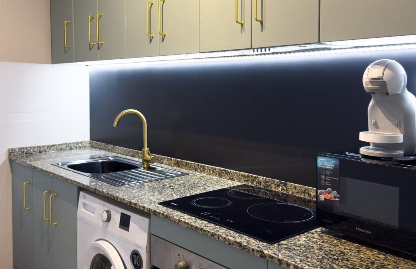 Rent in Torrevieja – Fully Equipped Kitchen with oven, washing machine, coffee machine, ceramic hob, and modern cabinets.